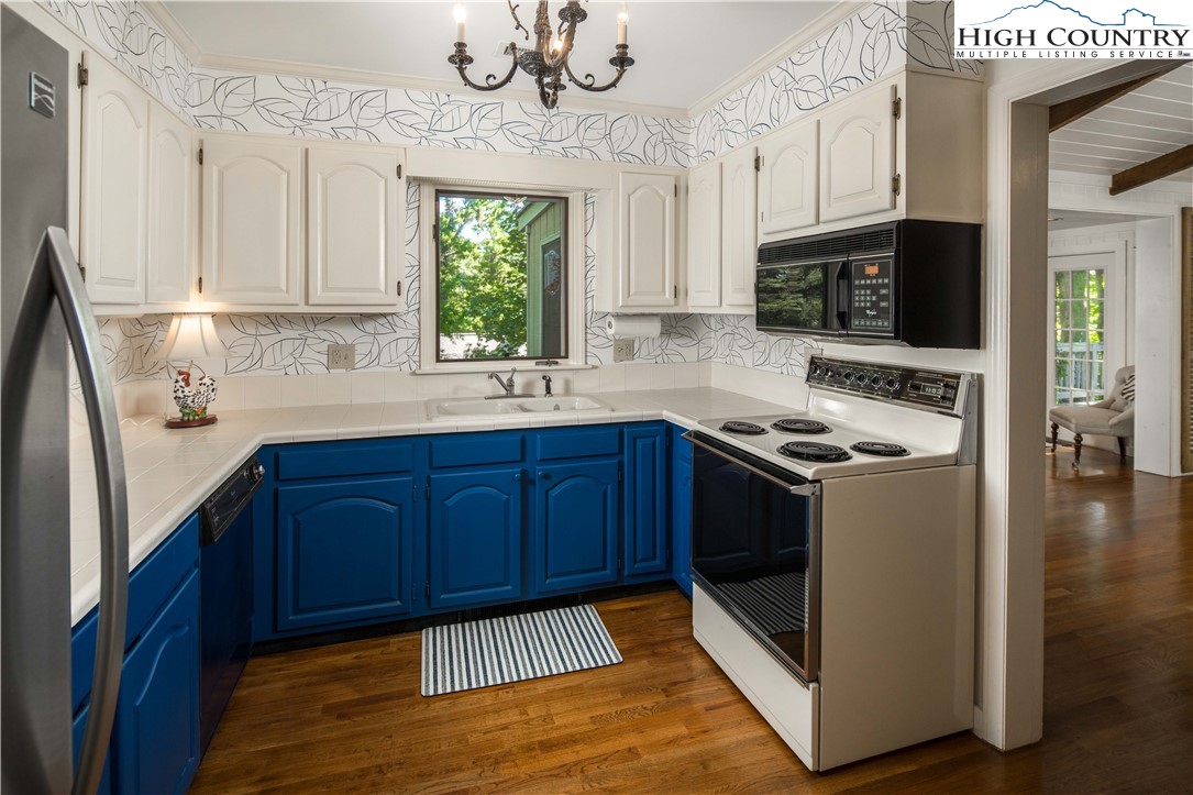 271 Pinnacle Avenue Blowing Rock, NC 28605 - Photo 18 of 43 a kitchen with stainless steel appliances granite countertop a stove a sink and a microwave