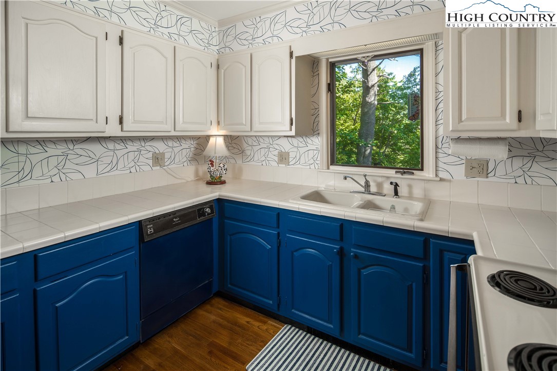 271 Pinnacle Avenue Blowing Rock, NC 28605 - Photo 19 of 43 a kitchen with stainless steel appliances granite countertop a sink and wooden cabinets