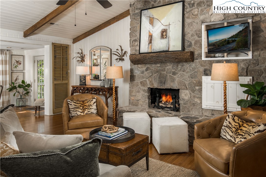 271 Pinnacle Avenue Blowing Rock, NC 28605 - Photo 7 of 43 a living room with furniture a flat screen tv and a fireplace