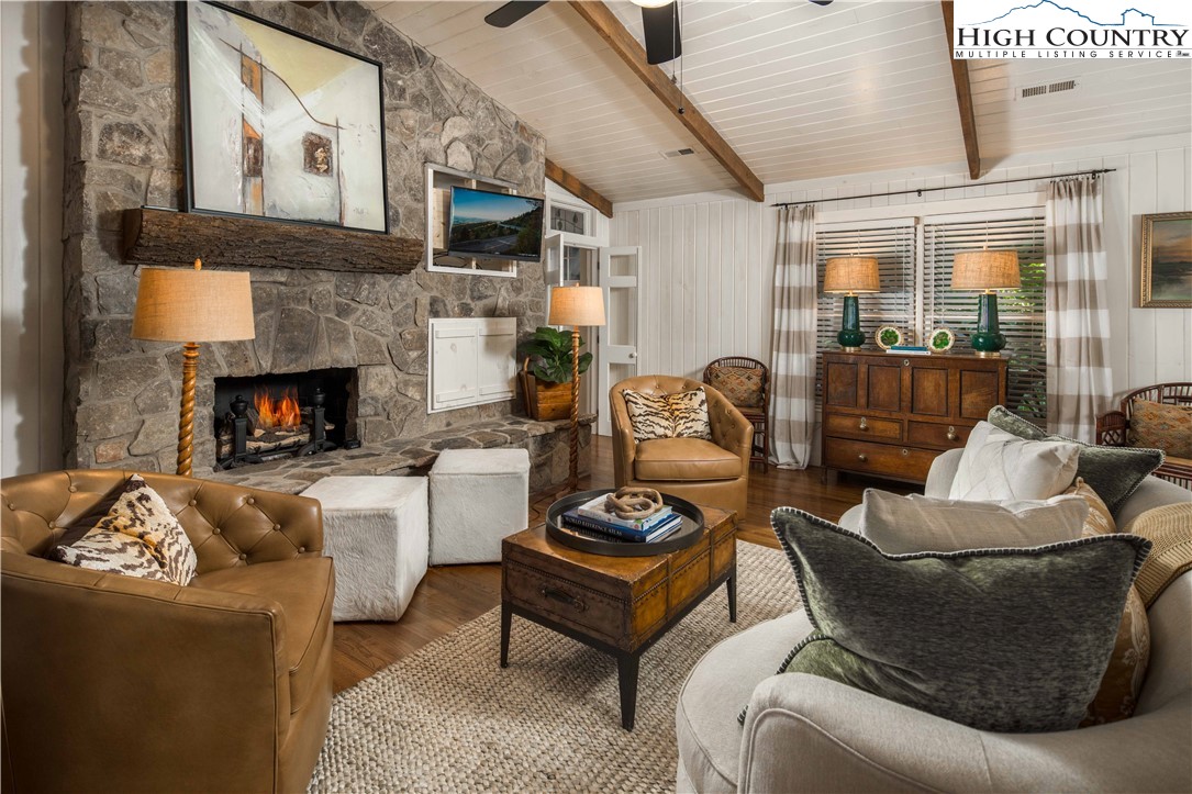 271 Pinnacle Avenue Blowing Rock, NC 28605 - Photo 9 of 43 a living room with furniture a fireplace and a flat screen tv