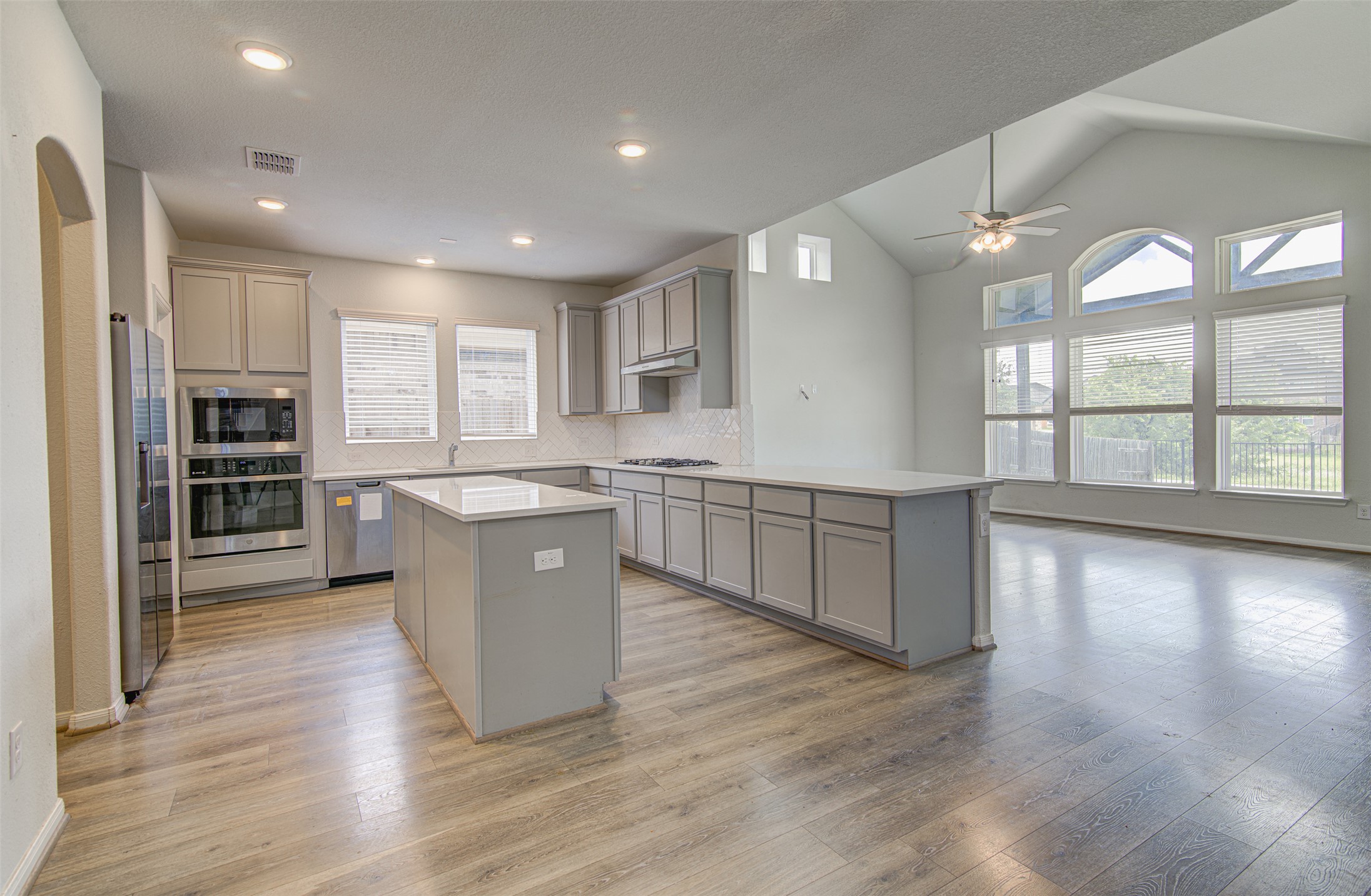 774 Cherrystone Loop Buda, TX 78610 - Photo 5 of 38 A well-lit kitchen with sleek countertops and abundant natural light from numerous windows, perfect for entertaining.