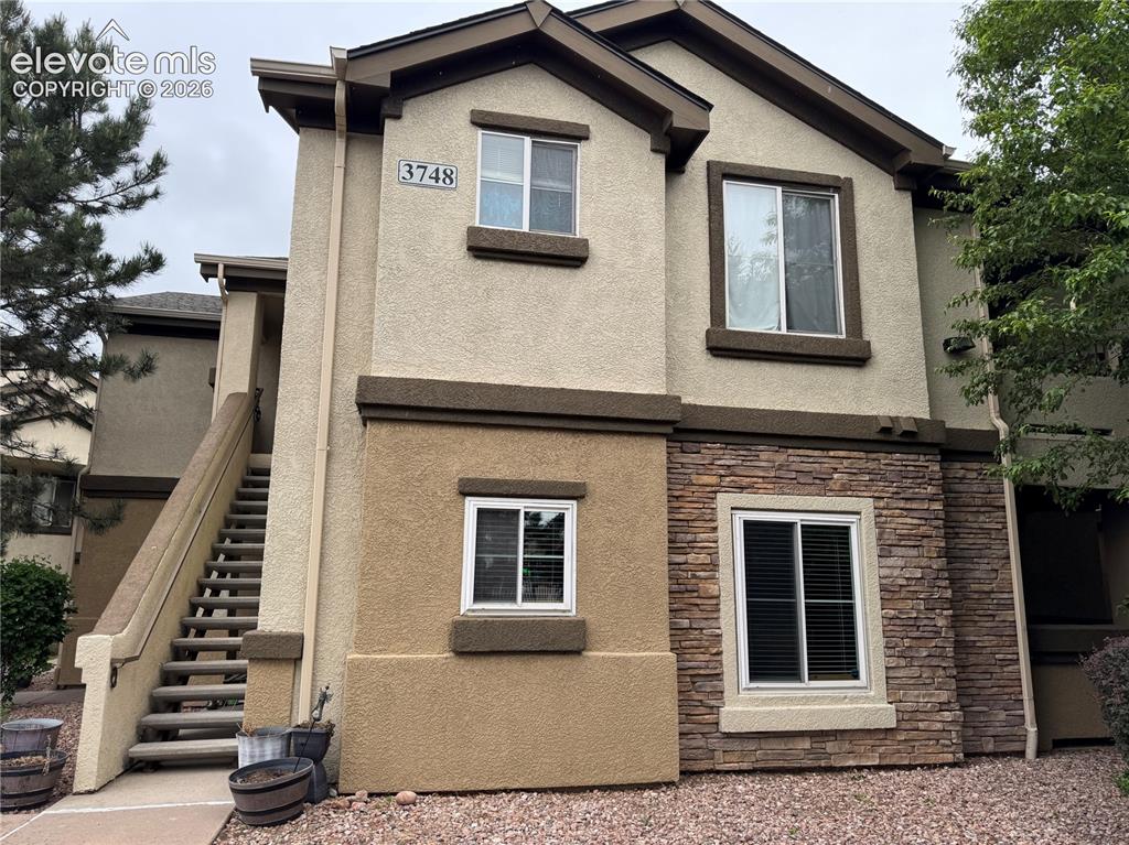 a front view of a house with stairs
