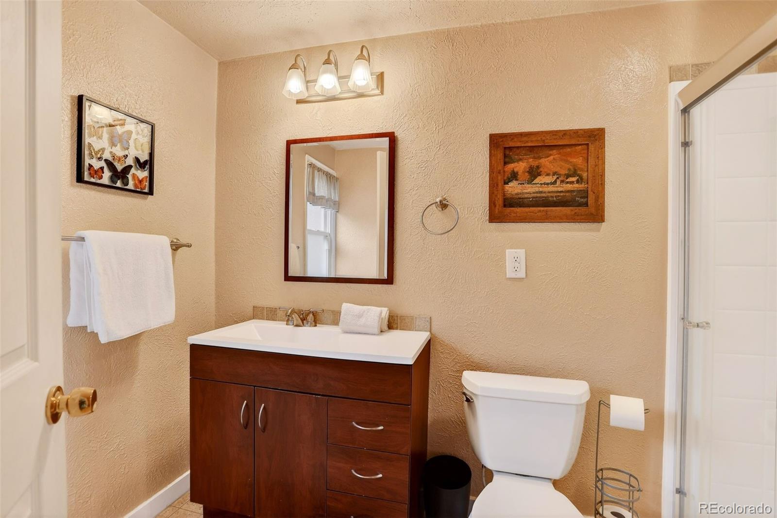 626 Aspen Lane Bailey, CO 80421 - Photo 17 of 47 a bathroom with a toilet sink and mirror