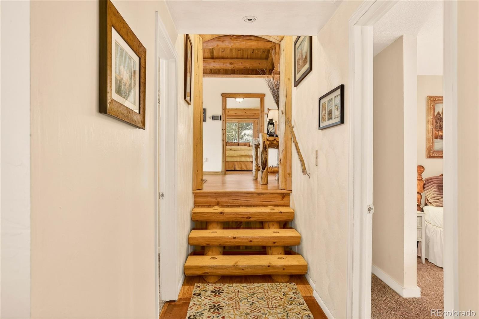 626 Aspen Lane Bailey, CO 80421 - Photo 19 of 47 a view of a hallway with wooden floor and entryway
