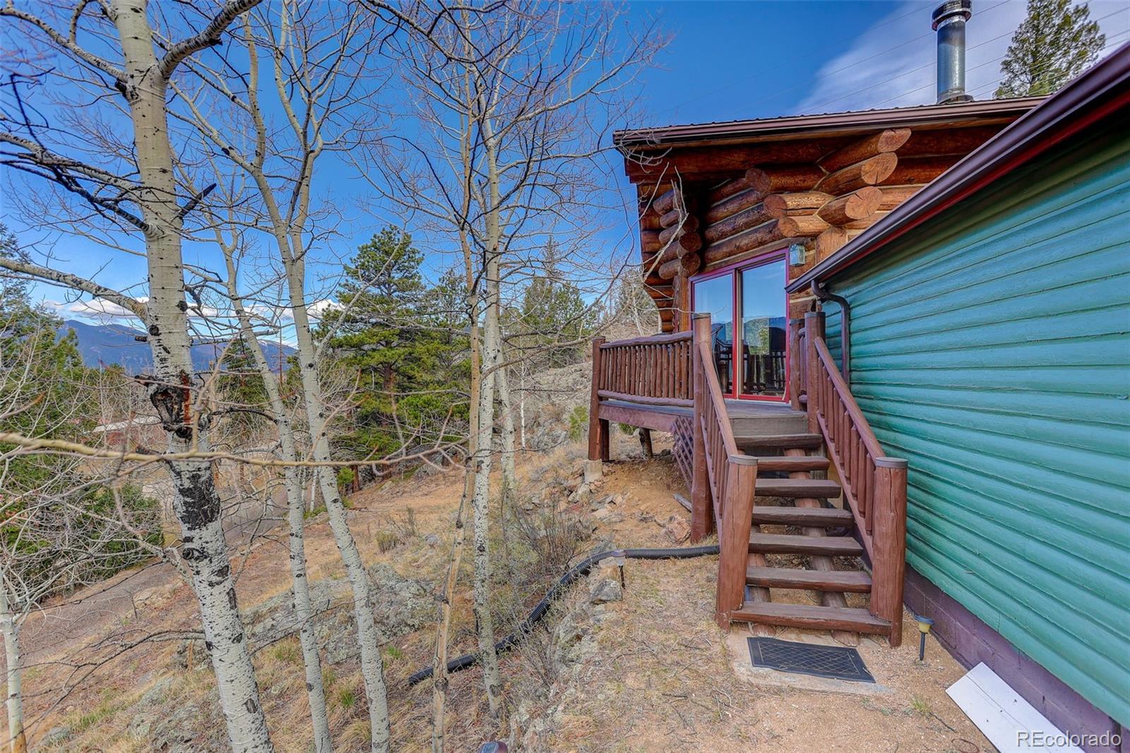 626 Aspen Lane Bailey, CO 80421 - Photo 25 of 47 a view of a backyard with chairs
