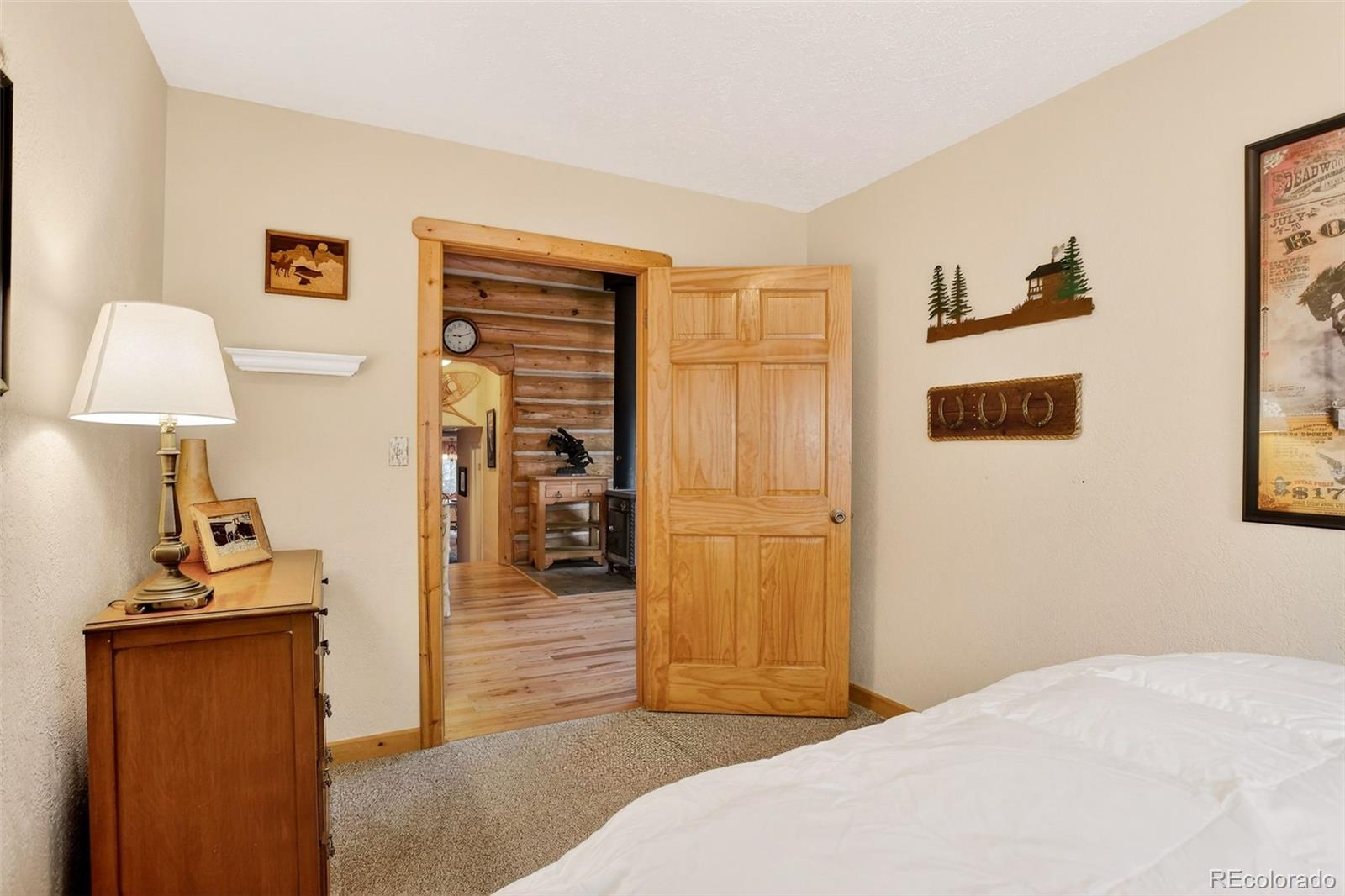 626 Aspen Lane Bailey, CO 80421 - Photo 31 of 47 a bedroom with a bed and a table
