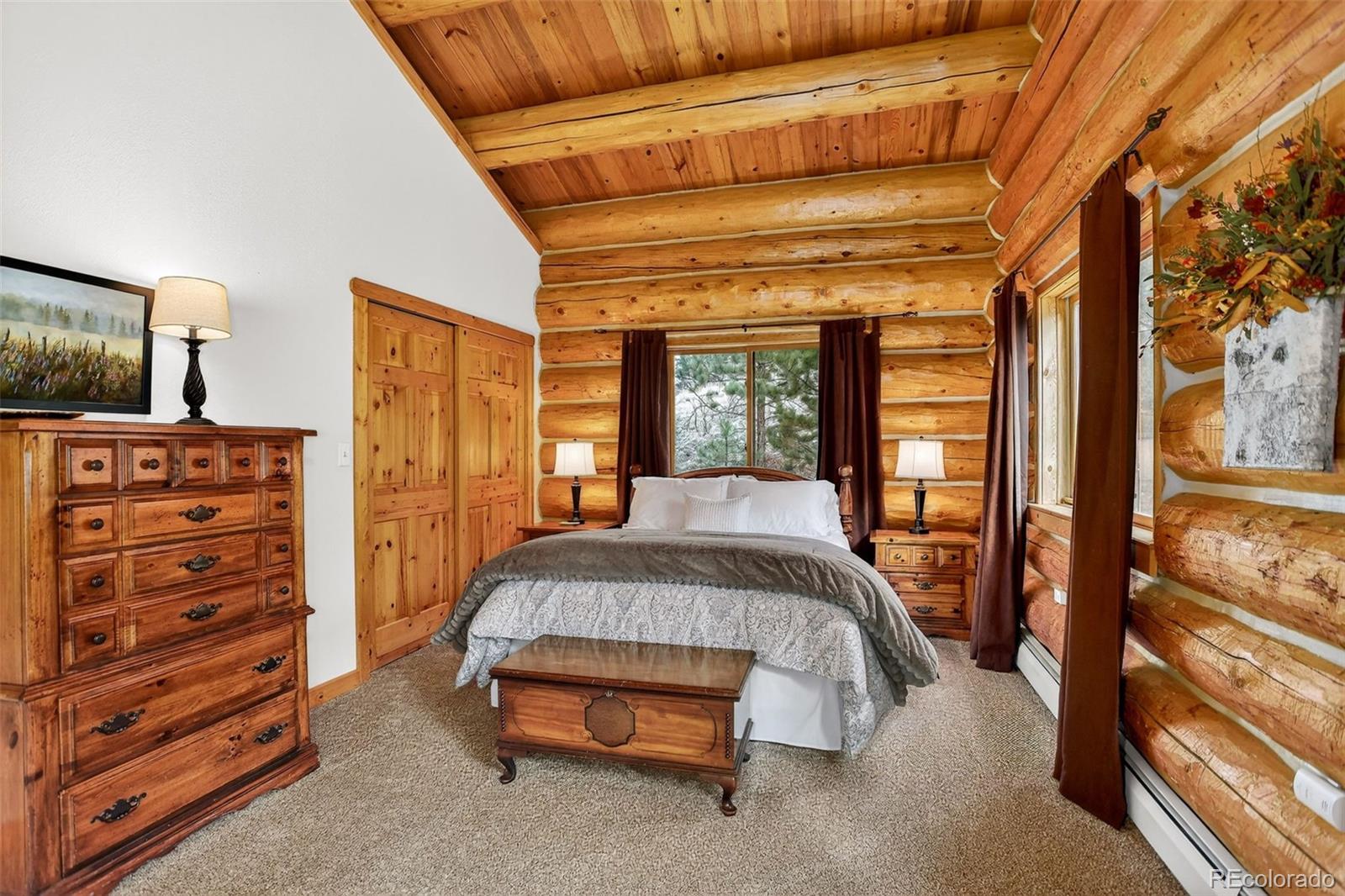 626 Aspen Lane Bailey, CO 80421 - Photo 33 of 47 a spacious bedroom with a bed and a dresser