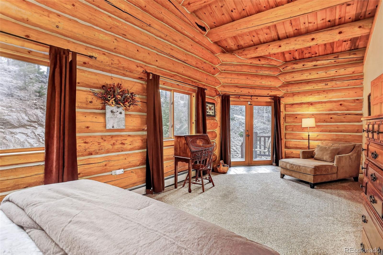 626 Aspen Lane Bailey, CO 80421 - Photo 34 of 47 a bedroom with furniture and large windows