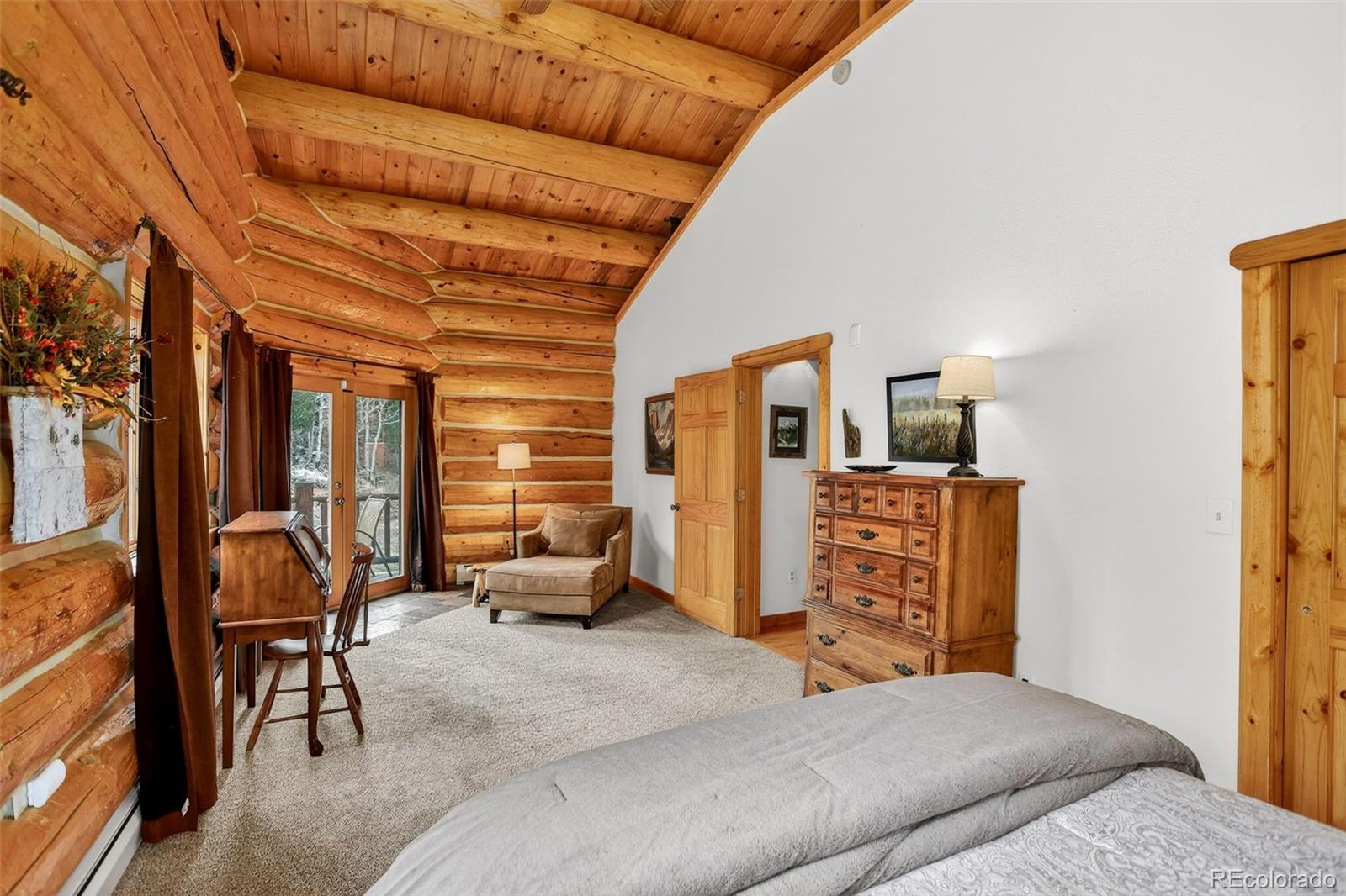 626 Aspen Lane Bailey, CO 80421 - Photo 35 of 47 a bedroom with furniture and large windows