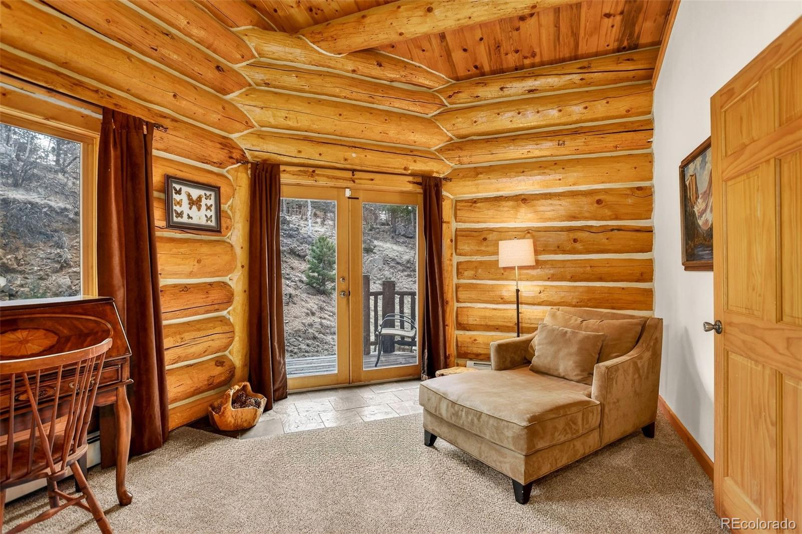 626 Aspen Lane Bailey, CO 80421 - Photo 36 of 47 a living room with furniture a flat screen tv and a walk in closet