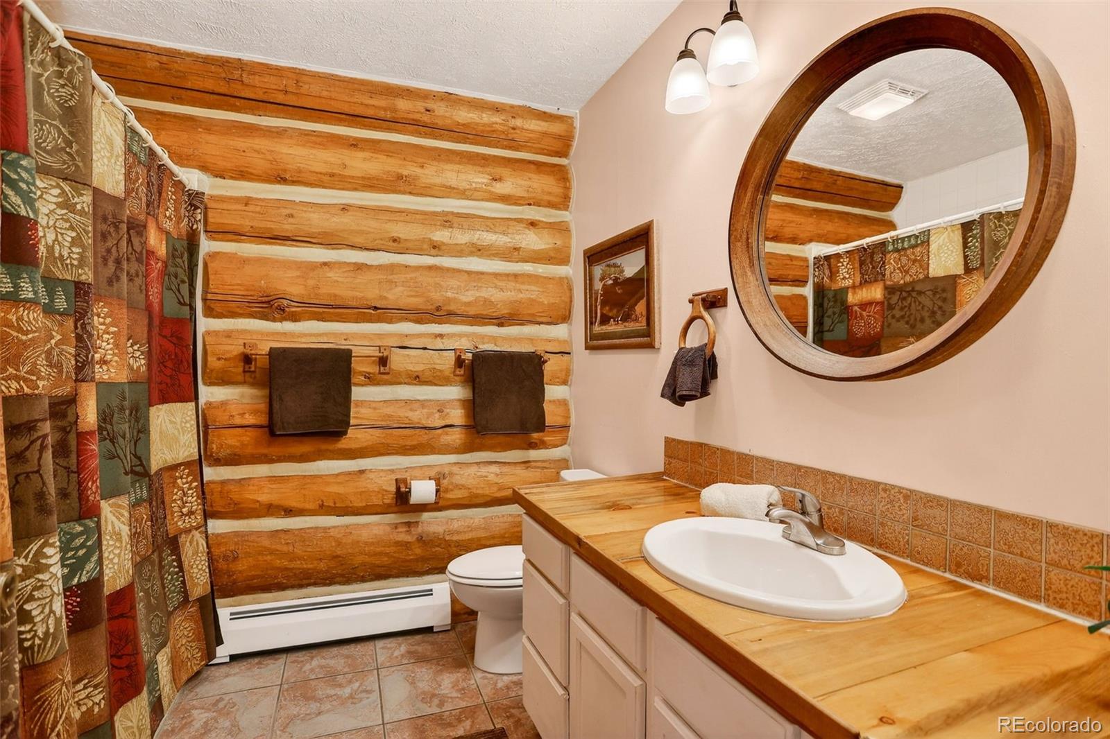 626 Aspen Lane Bailey, CO 80421 - Photo 37 of 47 a bathroom with a sink and a mirror