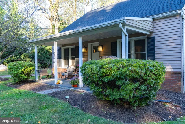 a view of a house with backyard and sitting area