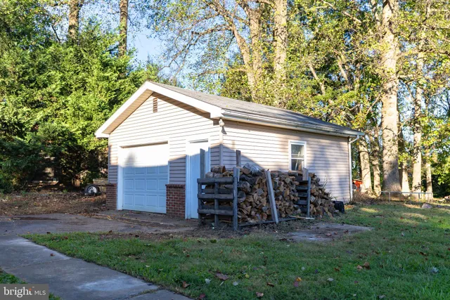 a view of a house with a yard and sitting area