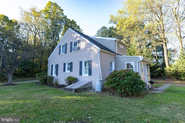 a view of a house with swimming pool and a yard