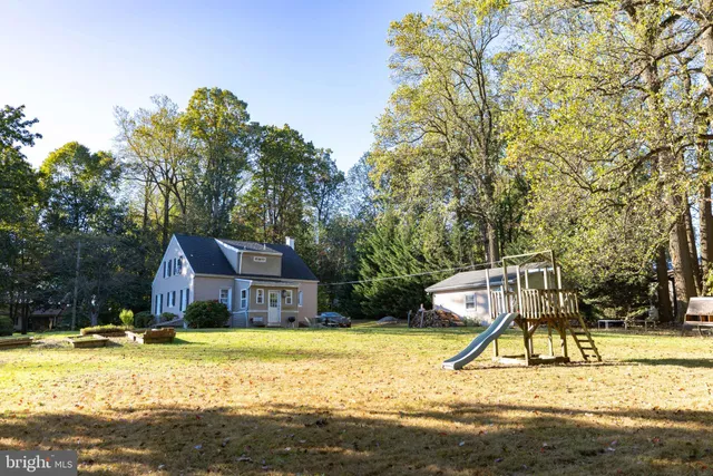a front view of a house with a garden and plants