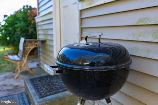 a view of a house with a yard and large trees