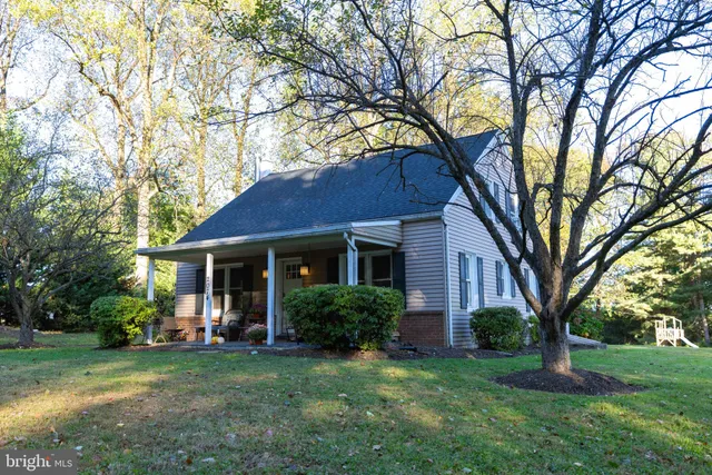 a view of house with yard and green space