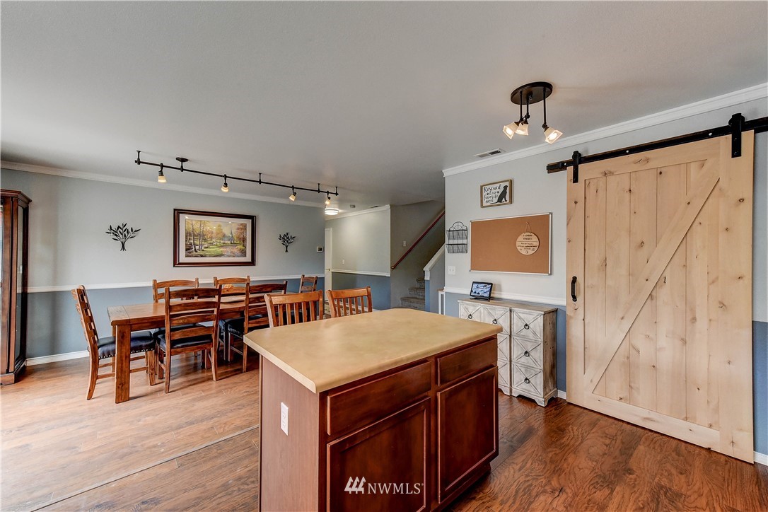 14155 Corbridge Road Southeast Monroe, WA 98272 - Photo 11 of 31 a view of a dining room with furniture and wooden floor