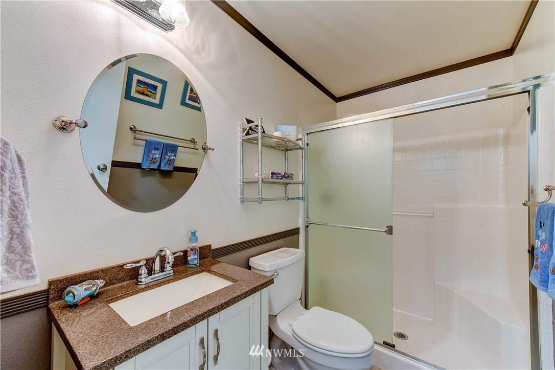 14155 Corbridge Road Southeast Monroe, WA 98272 - Photo 14 of 31 a bathroom with a sink vanity mirror and toilet