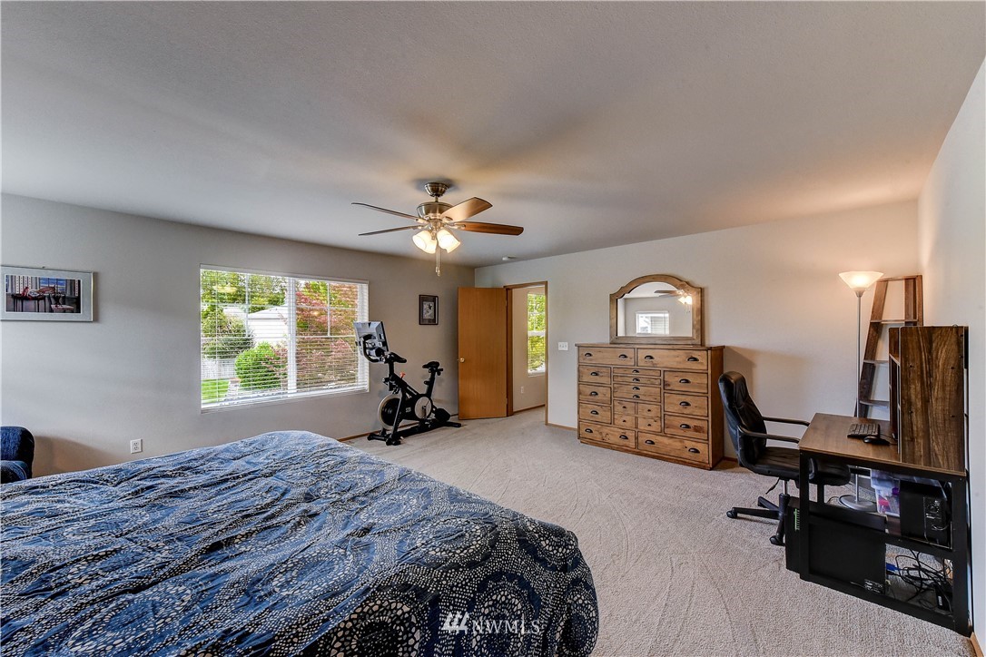 14155 Corbridge Road Southeast Monroe, WA 98272 - Photo 16 of 31 a bed room with a bed and a ceiling fan