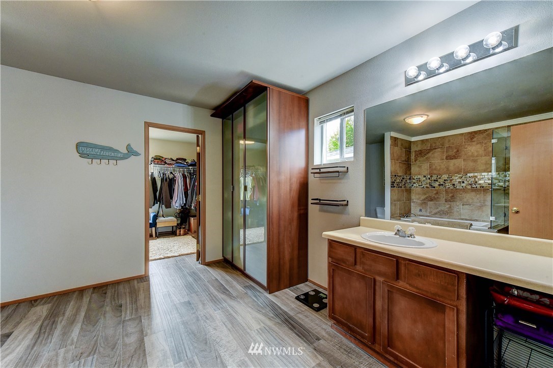14155 Corbridge Road Southeast Monroe, WA 98272 - Photo 18 of 31 a bathroom with a double vanity sink a mirror and a shower