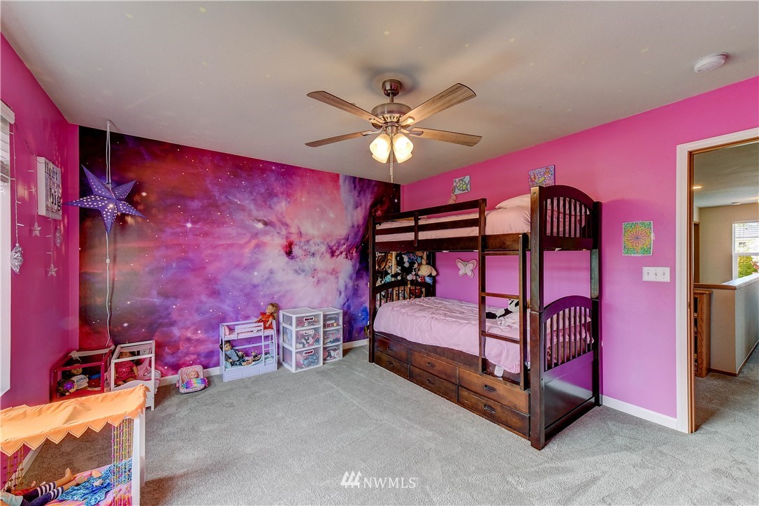 14155 Corbridge Road Southeast Monroe, WA 98272 - Photo 21 of 31 a bedroom with a bed and a chandelier
