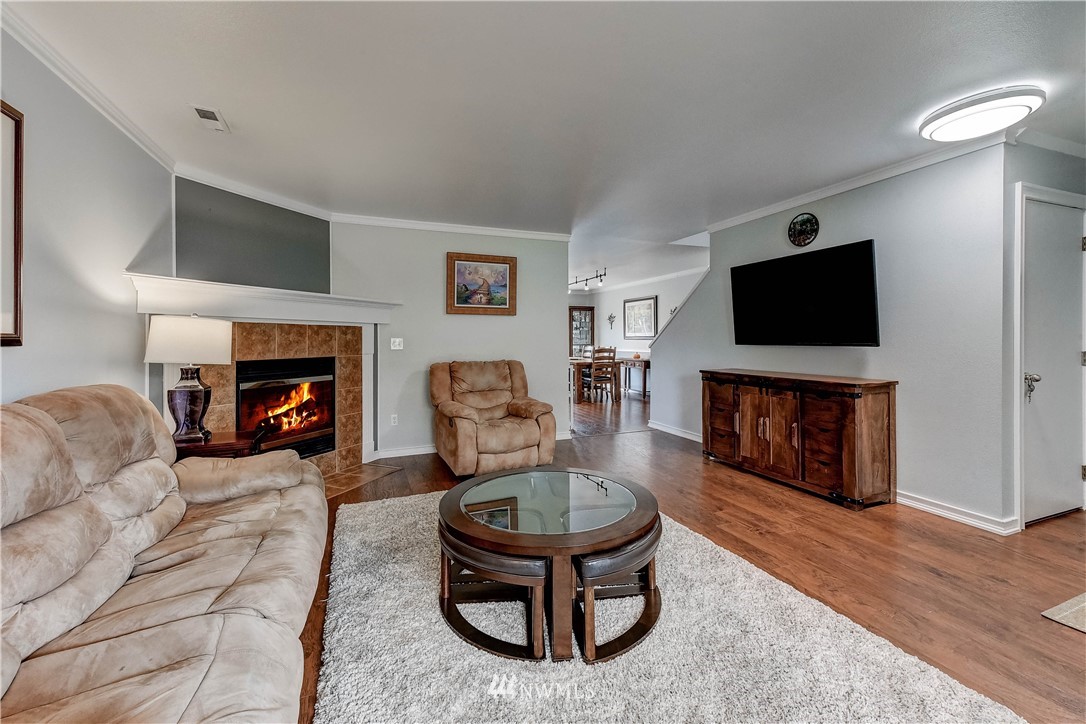 14155 Corbridge Road Southeast Monroe, WA 98272 - Photo 4 of 31 a living room with furniture a flat screen tv and a fireplace