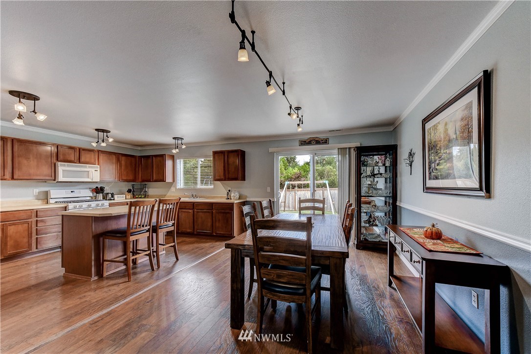 14155 Corbridge Road Southeast Monroe, WA 98272 - Photo 5 of 31 a view of a dining room with furniture window and wooden floor