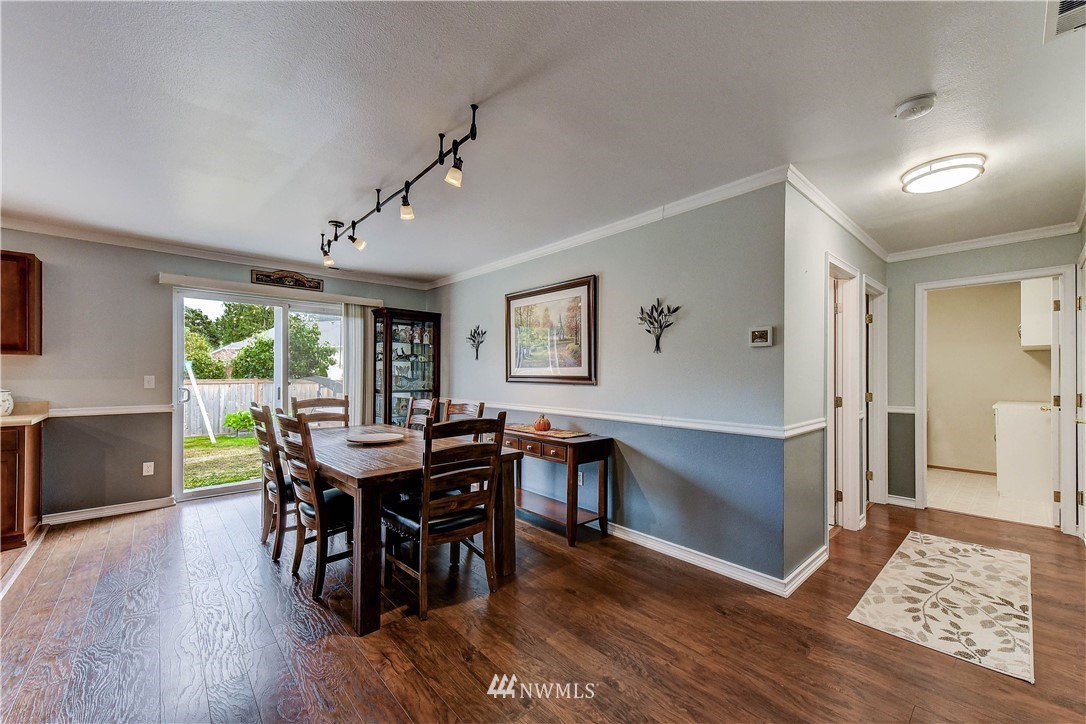 14155 Corbridge Road Southeast Monroe, WA 98272 - Photo 6 of 31 a view of a dining room with furniture window and wooden floor