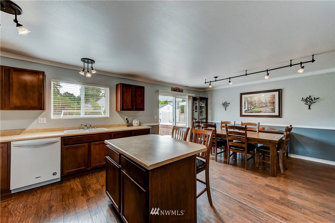 14155 Corbridge Road Southeast Monroe, WA 98272 - Photo 10 of 31 a large kitchen with kitchen island a sink table and chairs