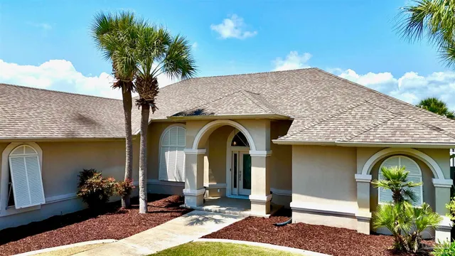 a front view of a house with garden