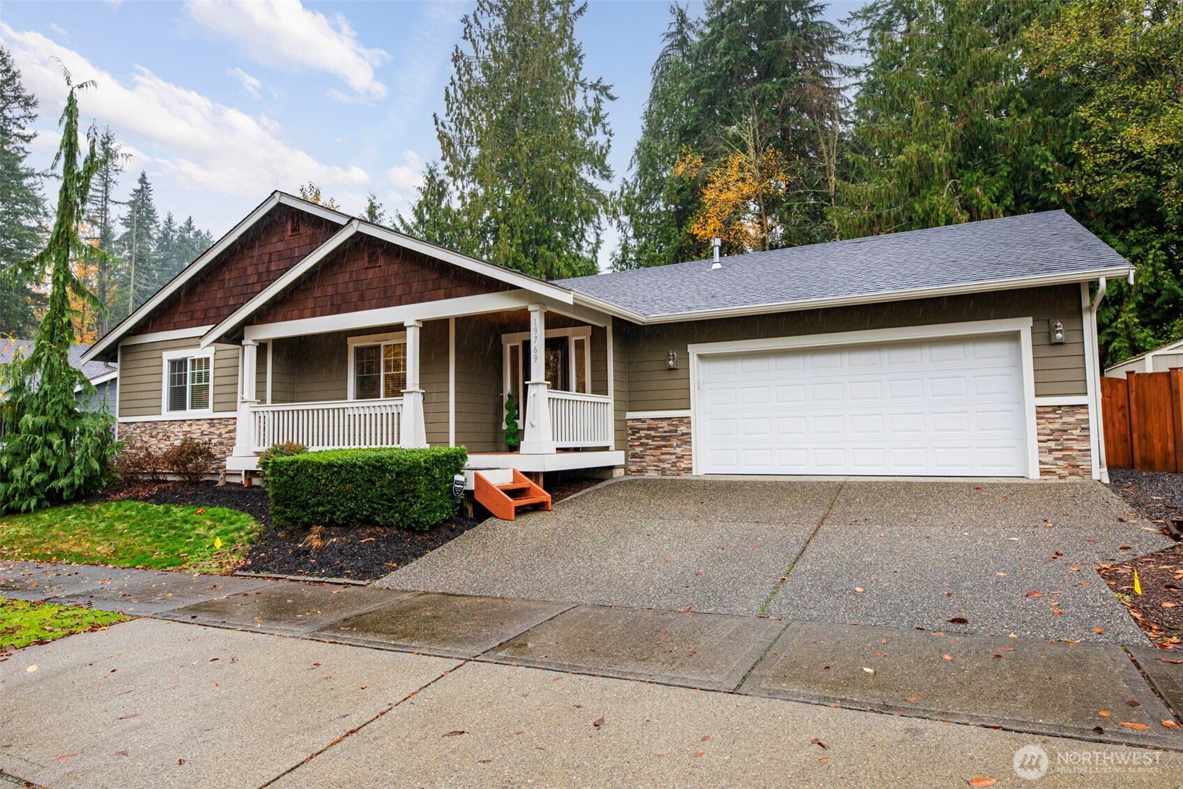 19769 Mountain Ridge Road Southeast Monroe, WA 98272 - Photo 3 of 38 a front view of a house with a yard and garage