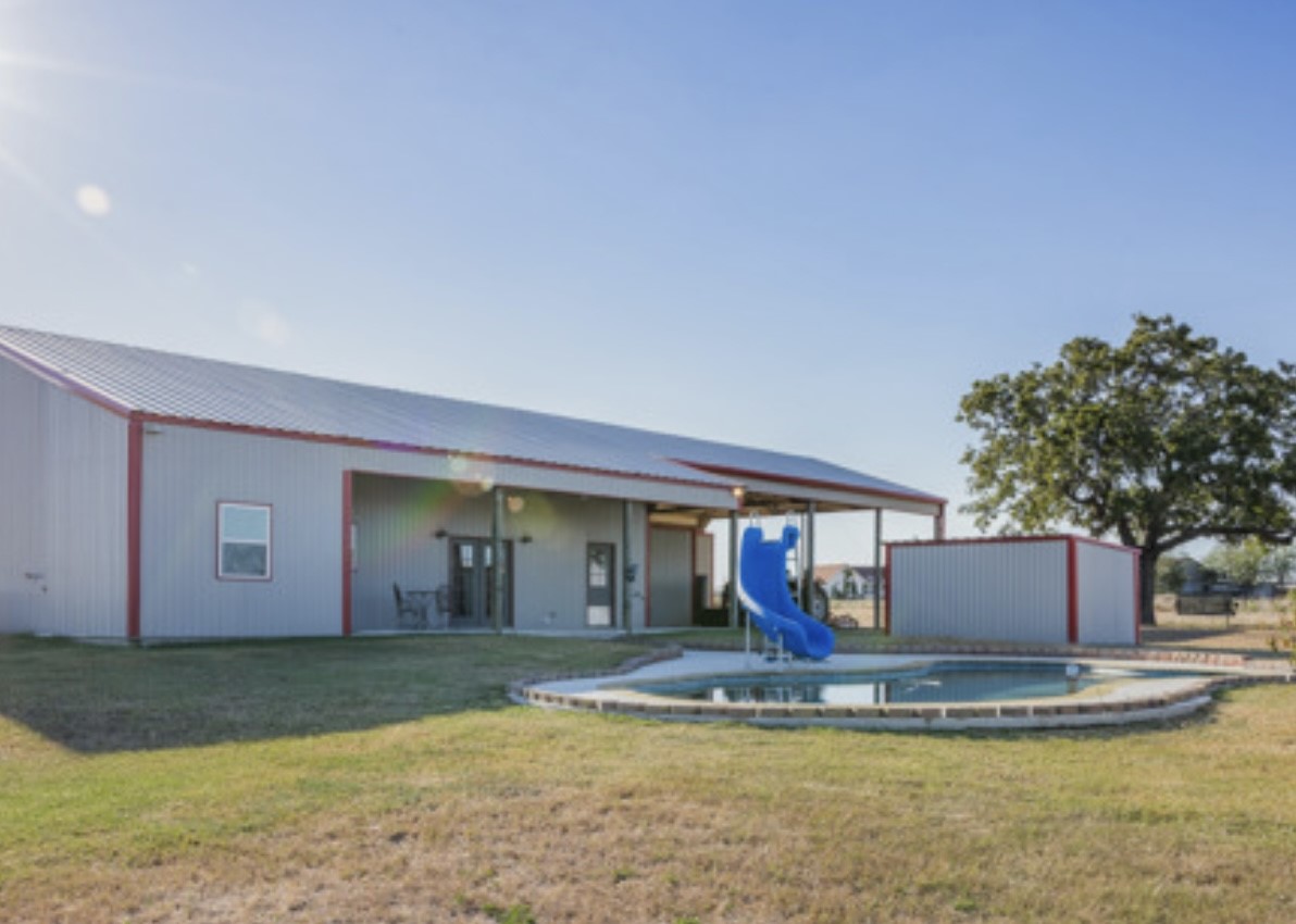 7210 Goehring Road Ledbetter, TX 78946 - Photo 9 of 47 a view of a house with swimming pool and a yard