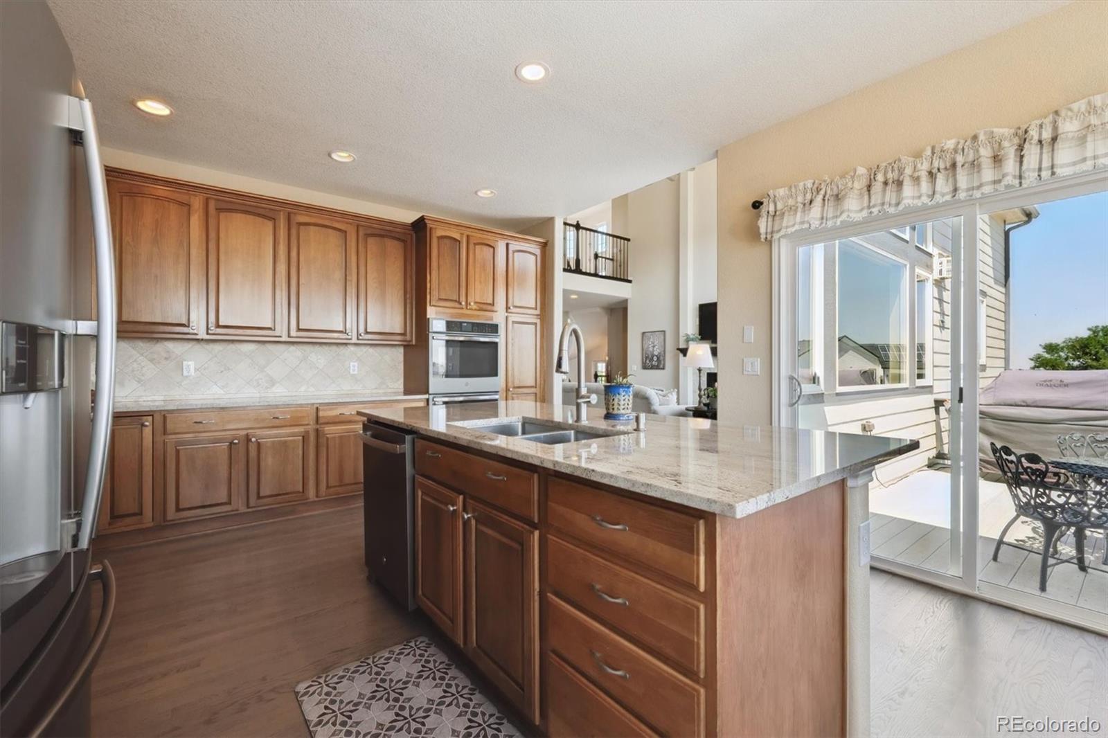 724 Imboden Road Watkins, CO 80137 - Photo 14 of 50 a kitchen with a sink cabinets and window