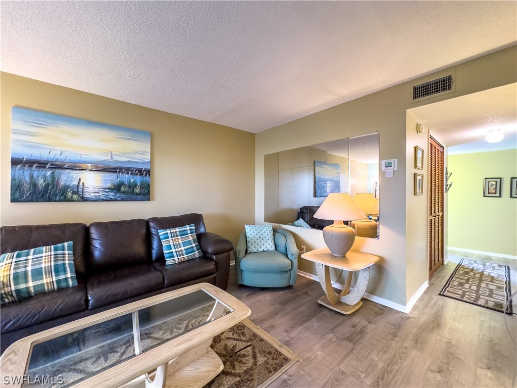 6777 Winkler Road, Unit 168 Fort Myers, FL 33919 - Photo 12 of 37 a living room with furniture and a flat screen tv