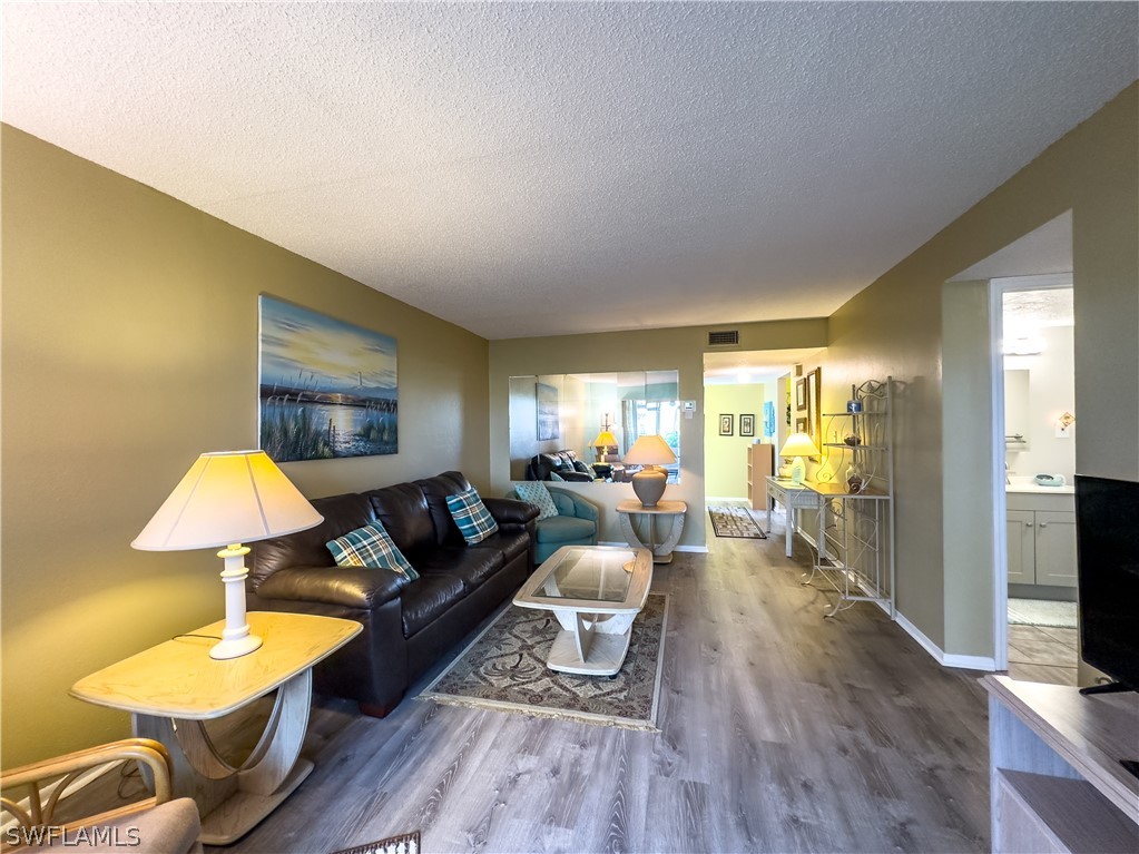 6777 Winkler Road, Unit 168 Fort Myers, FL 33919 - Photo 13 of 37 a living room with furniture and a flat screen tv