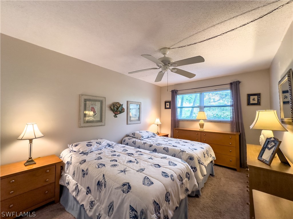6777 Winkler Road, Unit 168 Fort Myers, FL 33919 - Photo 15 of 37 a bedroom with a bed and a lamp