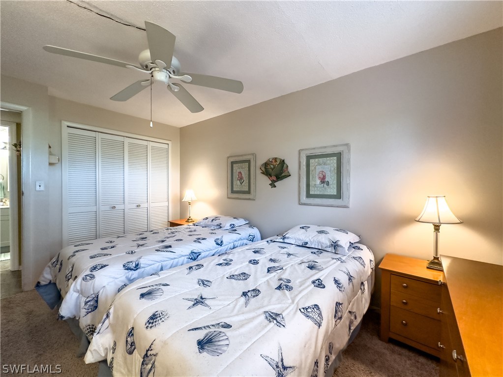 6777 Winkler Road, Unit 168 Fort Myers, FL 33919 - Photo 16 of 37 a bedroom with a bed and a chandelier