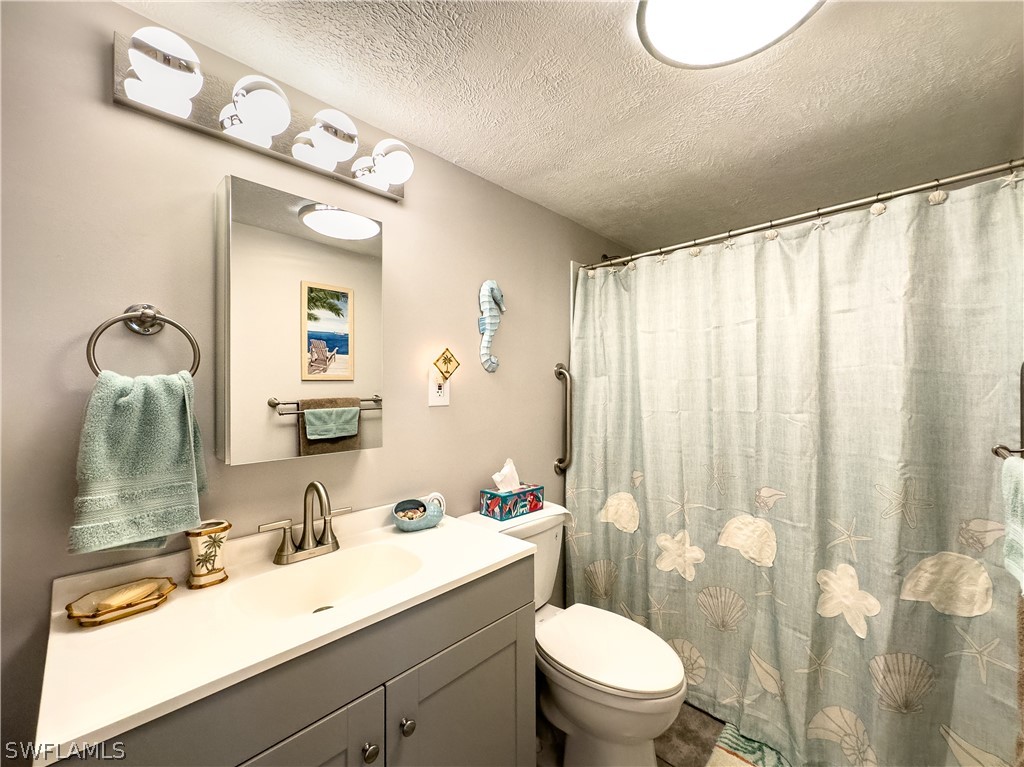 6777 Winkler Road, Unit 168 Fort Myers, FL 33919 - Photo 17 of 37 a bathroom with a sink vanity mirror and toilet