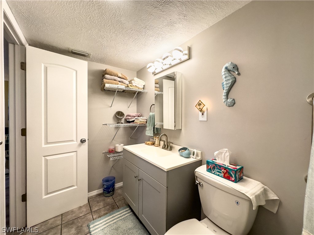 6777 Winkler Road, Unit 168 Fort Myers, FL 33919 - Photo 18 of 37 a bathroom with a toilet sink vanity and mirror