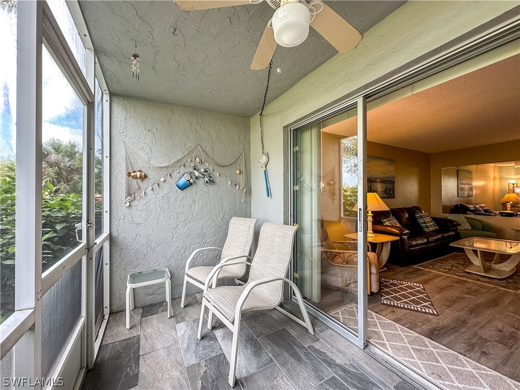 6777 Winkler Road, Unit 168 Fort Myers, FL 33919 - Photo 21 of 37 a view of a dining room with furniture a chandelier and wooden floor