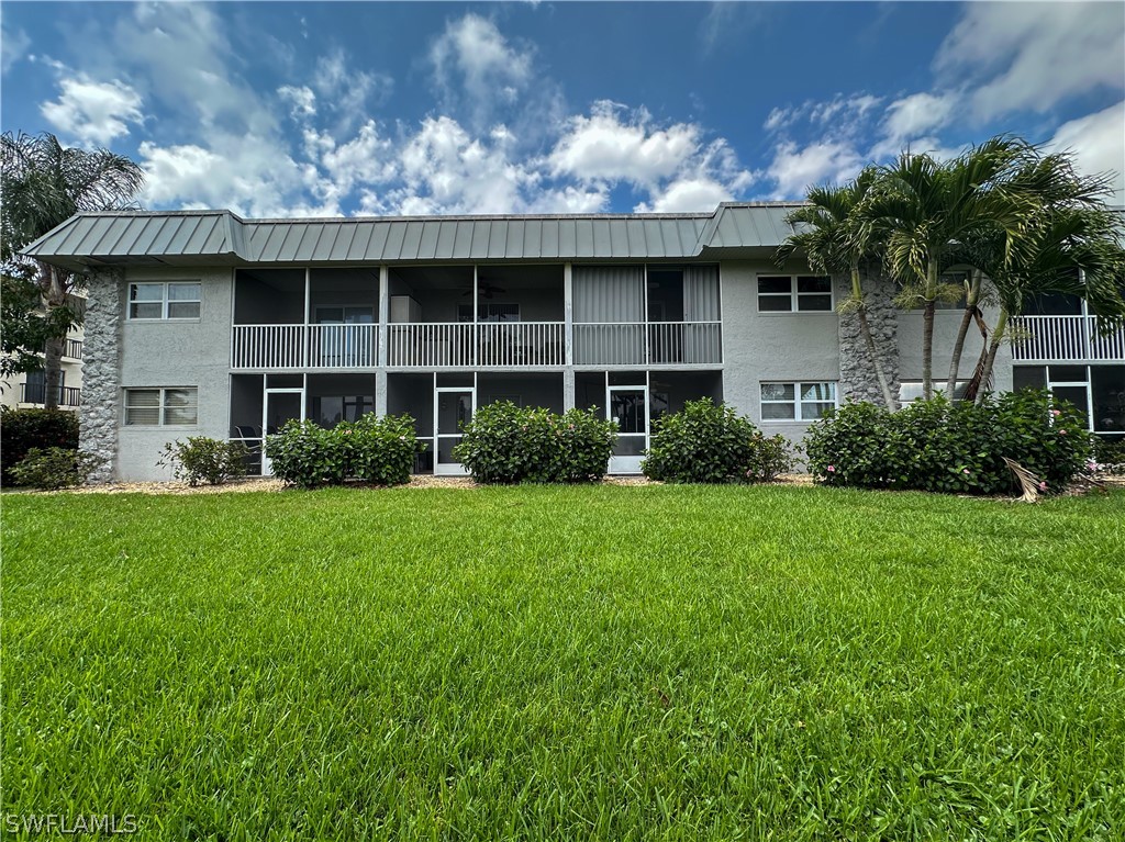 6777 Winkler Road, Unit 168 Fort Myers, FL 33919 - Photo 24 of 37 a front view of a house with a garden