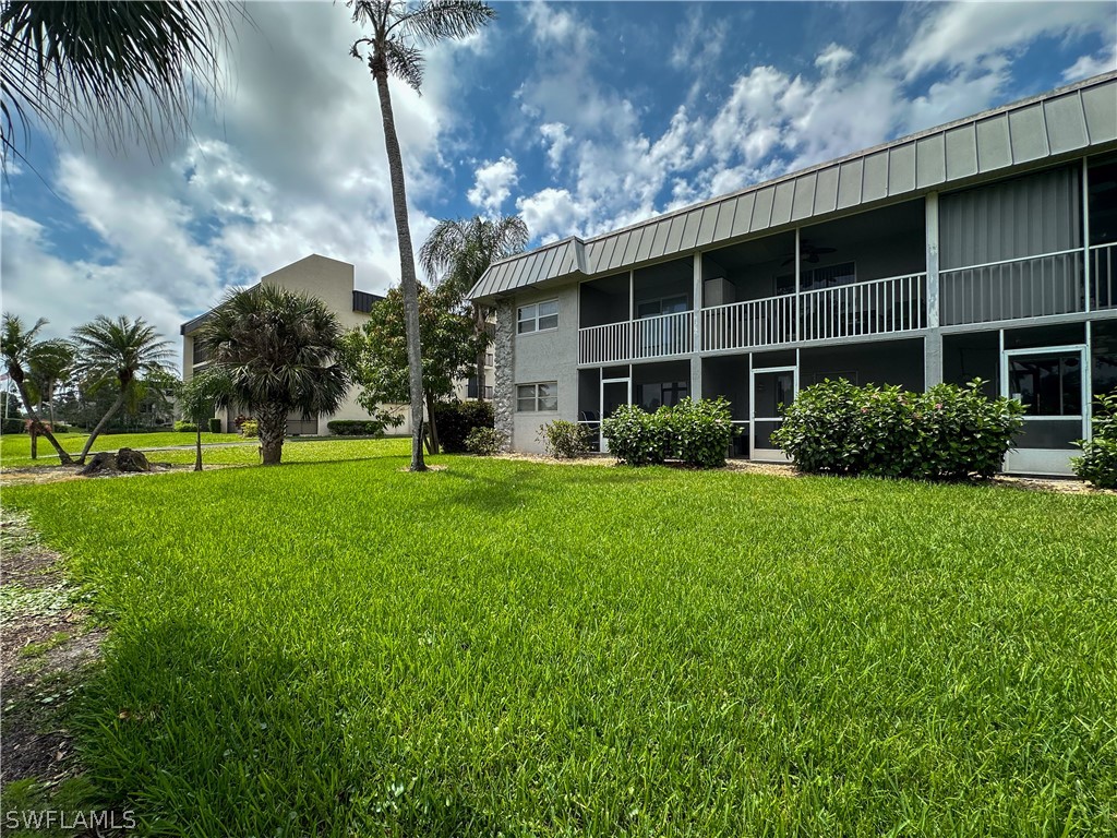 6777 Winkler Road, Unit 168 Fort Myers, FL 33919 - Photo 25 of 37 a front view of a building with garden
