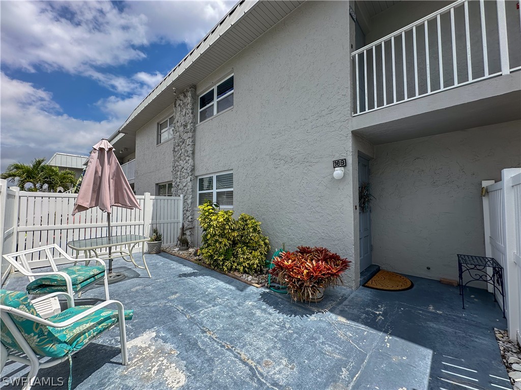 6777 Winkler Road, Unit 168 Fort Myers, FL 33919 - Photo 26 of 37 a backyard of a house with outdoor seating