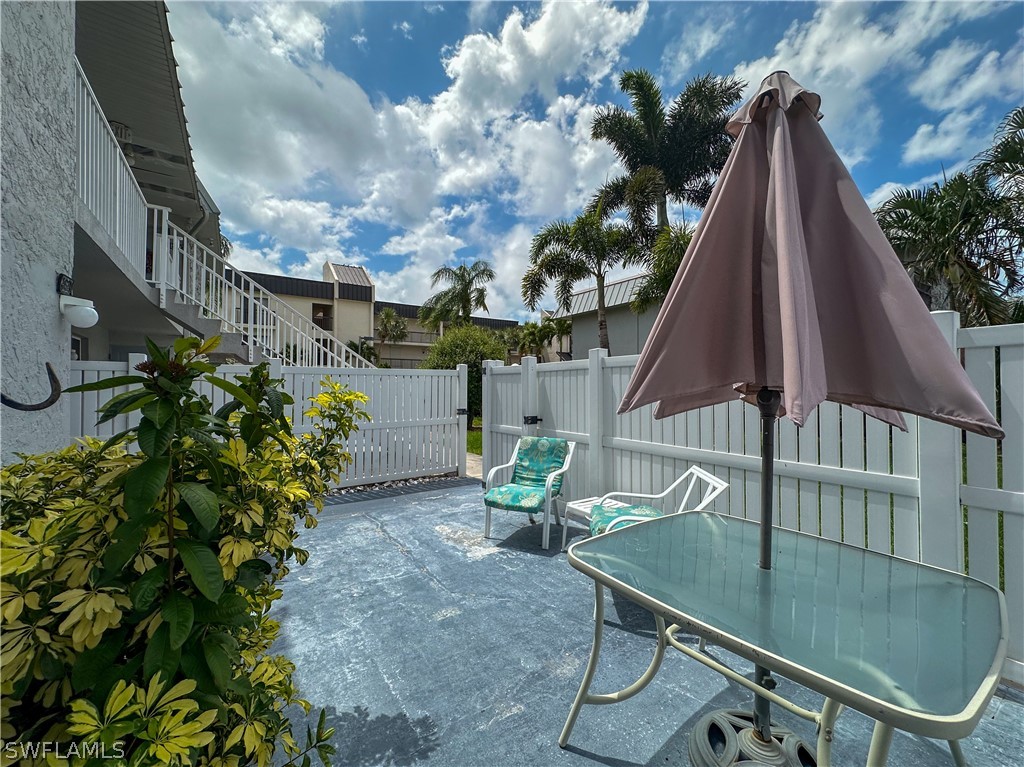 6777 Winkler Road, Unit 168 Fort Myers, FL 33919 - Photo 27 of 37 a backyard of a house with table and chairs