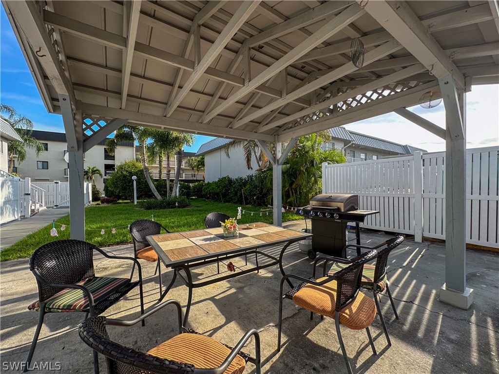 6777 Winkler Road, Unit 168 Fort Myers, FL 33919 - Photo 29 of 37 a patio with a table and chairs