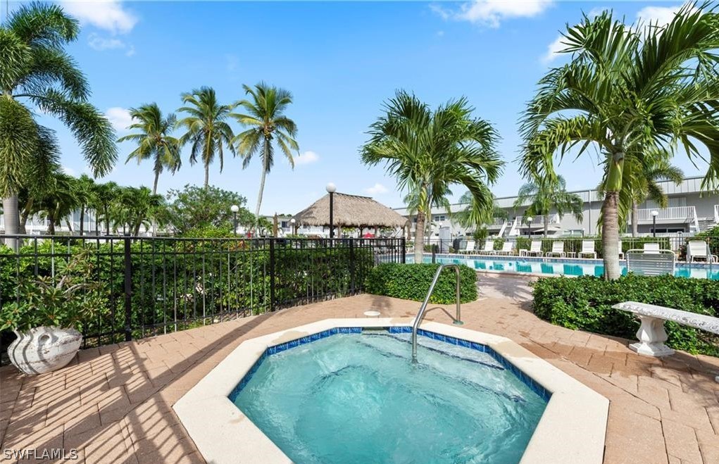 6777 Winkler Road, Unit 168 Fort Myers, FL 33919 - Photo 33 of 37 a swimming pool with outdoor seating and garden