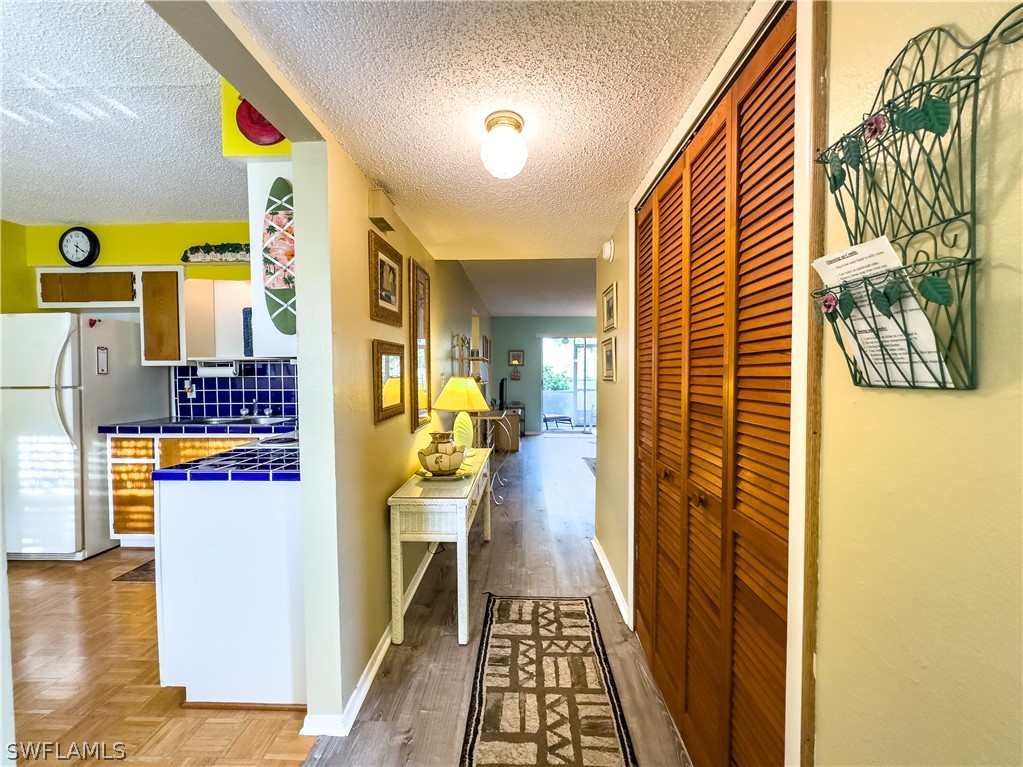 6777 Winkler Road, Unit 168 Fort Myers, FL 33919 - Photo 5 of 37 a view of a hallway with wooden floor