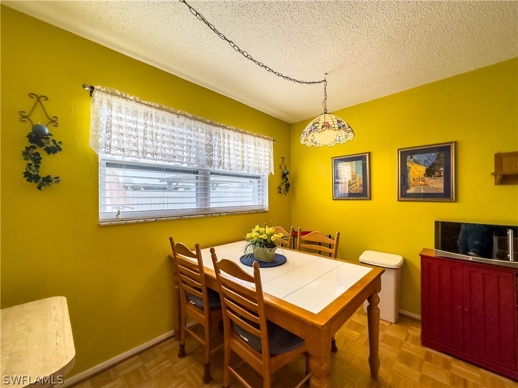 6777 Winkler Road, Unit 168 Fort Myers, FL 33919 - Photo 9 of 37 a view of a dining room with furniture and a window