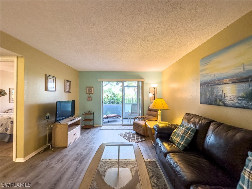 6777 Winkler Road, Unit 168 Fort Myers, FL 33919 - Photo 10 of 37 a living room with furniture and a flat screen tv